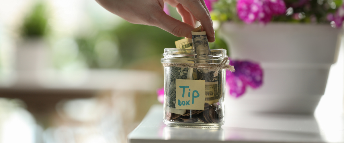 tip jar with pink flowers in background